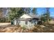 Charming exterior view of this quaint home surrounded by mature trees and a natural landscape at 2224 Elizabeth Se Ave, Smyrna, GA 30080