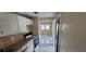 Efficient kitchen with white cabinets and a view into the brightly lit adjacent room at 2224 Elizabeth Se Ave, Smyrna, GA 30080