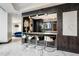 Stylish bar area featuring modern stools, sleek countertops, and mirrored backsplash at 400 W Peachtree Nw St # 3204, Atlanta, GA 30308