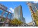 Low angle of high rise building with blue sky overhead shows trees lining the street at 400 W Peachtree Nw St # 3204, Atlanta, GA 30308