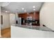 Modern kitchen featuring stainless steel appliances, wooden cabinets, and a granite counter breakfast bar at 400 W Peachtree Nw St # 3204, Atlanta, GA 30308