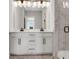 Bright bathroom featuring double vanity, modern lighting, and a frameless glass shower at 911 Echo Park Dr, Suwanee, GA 30024