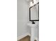 Powder room featuring a pedestal sink, dark accents, and tile flooring at 911 Echo Park Dr, Suwanee, GA 30024