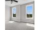 Bedroom featuring neutral walls, carpet floors, and two large windows at 911 Echo Park Dr, Suwanee, GA 30024