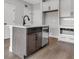 Modern kitchen island with sink, dishwasher, and white countertop at 911 Echo Park Dr, Suwanee, GA 30024