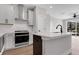 Modern kitchen featuring stainless steel appliances and sleek white cabinetry at 911 Echo Park Dr, Suwanee, GA 30024
