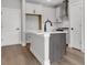 Modern kitchen island with white countertops and stainless steel appliances at 911 Echo Park Dr, Suwanee, GA 30024