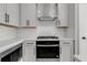 Stylish kitchen featuring white cabinetry, modern appliances, and a stainless steel range hood at 911 Echo Park Dr, Suwanee, GA 30024