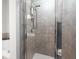 Modern bathroom with tiled shower, bathtub, and glass door at 1605 Ridenour Nw Pkwy, Kennesaw, GA 30152