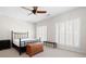 Well-lit bedroom with neutral carpet, ceiling fan, and ample natural light from windows at 1605 Ridenour Nw Pkwy, Kennesaw, GA 30152