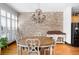 Bright dining room features an exposed brick wall, wood floors and modern appliances at 1605 Ridenour Nw Pkwy, Kennesaw, GA 30152