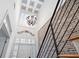 Bright foyer features a high ceiling with chandelier and brick accent wall and staircase at 1605 Ridenour Nw Pkwy, Kennesaw, GA 30152