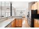 Bright kitchen featuring stainless steel appliances, wood cabinets, and an open layout to the dining area at 1605 Ridenour Nw Pkwy, Kennesaw, GA 30152