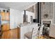 Open concept kitchen with a breakfast bar overlooking the living room with brick fireplace at 1605 Ridenour Nw Pkwy, Kennesaw, GA 30152