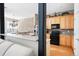 Stylish kitchen featuring light wood cabinets, black appliances, and a connecting breakfast bar at 1605 Ridenour Nw Pkwy, Kennesaw, GA 30152