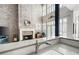 A kitchen with exposed brick, a modern countertop, stainless steel sink, and fireplace view at 1605 Ridenour Nw Pkwy, Kennesaw, GA 30152