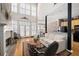 Inviting living room with a fireplace, large windows, and hardwood floors throughout at 1605 Ridenour Nw Pkwy, Kennesaw, GA 30152