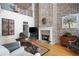 Cozy living room with a brick fireplace, hardwood floors, and comfortable seating at 1605 Ridenour Nw Pkwy, Kennesaw, GA 30152