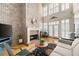 Bright living room featuring a fireplace, French doors, and beautiful hardwood flooring at 1605 Ridenour Nw Pkwy, Kennesaw, GA 30152