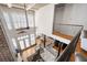 Open-concept living room with hardwood floors, brick accent wall, and modern railing at 1605 Ridenour Nw Pkwy, Kennesaw, GA 30152