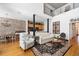 Bright living room with hardwood floors and access to dining area and kitchen at 1605 Ridenour Nw Pkwy, Kennesaw, GA 30152