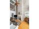 Bright living room with a fireplace, hardwood floors, and a balcony overlooking the space at 1605 Ridenour Nw Pkwy, Kennesaw, GA 30152