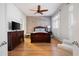 Spacious main bedroom with exposed brick wall, wood floors, and plantation shutters at 1605 Ridenour Nw Pkwy, Kennesaw, GA 30152