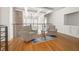 Cozy upstairs sitting area featuring hardwood floors, brick accent wall, and modern railing at 1605 Ridenour Nw Pkwy, Kennesaw, GA 30152