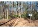 A wildlife sanctuary trail entrance sign with wooded areas and natural foliage surrounds at 1605 Ridenour Nw Pkwy, Kennesaw, GA 30152