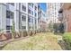 The shared backyard has newly installed landscaping with views of the building at 3435 Kingsboro Ne Rd # 1701, Atlanta, GA 30326