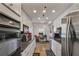 Galley kitchen with stainless steel appliances, granite counters, and white cabinets at 3435 Kingsboro Ne Rd # 1701, Atlanta, GA 30326