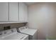 Laundry room with a washing machine, dryer, and white cabinetry offers efficient space at 3435 Kingsboro Ne Rd # 1701, Atlanta, GA 30326