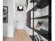 Modern hallway with light wood floors, white walls, and decorative shelving to add style at 567 Ponce De Leon Ne Ave # 317, Atlanta, GA 30308
