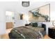 Bright bedroom boasts artistic decor, a comfortable bed, and an attached bathroom for convenience at 567 Ponce De Leon Ne Ave # 317, Atlanta, GA 30308