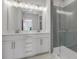 Modern primary bathroom featuring dual sinks, stylish lighting, and a glass-enclosed shower at 901 Echo Park Dr, Suwanee, GA 30024