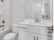 Clean white bathroom with a single sink vanity, toilet, and shower-tub combination at 901 Echo Park Dr, Suwanee, GA 30024