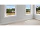Bright bedroom with three windows offering views of the landscape and neutral carpet at 901 Echo Park Dr, Suwanee, GA 30024