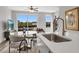 Bright living room features a round dining table, modern furnishings, and large windows overlooking the outdoors at 901 Echo Park Dr, Suwanee, GA 30024