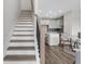 Staircase leading to a modern living space with hardwood floors and open floor plan at 901 Echo Park Dr, Suwanee, GA 30024