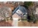 Aerial view of a well-maintained home showcasing its brick facade, mature trees, and manicured landscaping at 1224 Indian Hills Pkwy, Marietta, GA 30062