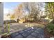 Private backyard features stone patio, grassy area, and mature trees for shade and seclusion at 1224 Indian Hills Pkwy, Marietta, GA 30062
