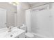 Clean, white bathroom with a shower-tub combo, single sink vanity and ample lighting at 1224 Indian Hills Pkwy, Marietta, GA 30062