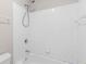 Bathroom shower and tub featuring bright white tiling and modern fixtures at 1224 Indian Hills Pkwy, Marietta, GA 30062