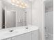 Clean bathroom with a double sink vanity, neutral paint, and a mirrored wall providing ample light at 1224 Indian Hills Pkwy, Marietta, GA 30062
