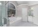 Bathroom featuring a glass shower, bathtub, white counters, and gold fixtures at 1224 Indian Hills Pkwy, Marietta, GA 30062