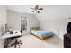 Comfortable bedroom with a ceiling fan, carpet, and a built-in desk, ideal for studying or relaxing at 1224 Indian Hills Pkwy, Marietta, GA 30062