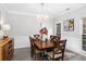 Elegant dining room with a chandelier, wood table, and wainscoting at 1224 Indian Hills Pkwy, Marietta, GA 30062