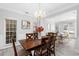 Bright dining room with wood table and views to living room and windows at 1224 Indian Hills Pkwy, Marietta, GA 30062