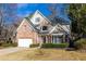 Charming brick and siding two-story home with a well-manicured front lawn and attached garage at 1224 Indian Hills Pkwy, Marietta, GA 30062