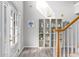 Bright foyer with hardwood floors, staircase, and a decorative shelving unit at 1224 Indian Hills Pkwy, Marietta, GA 30062